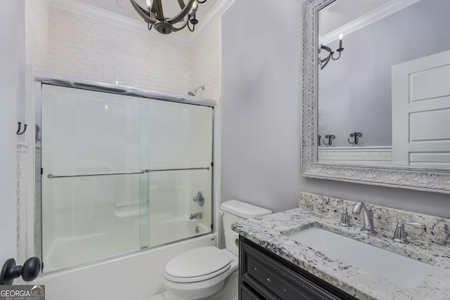 full bathroom featuring toilet, combined bath / shower with glass door, crown molding, and vanity