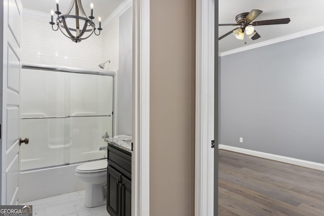 bathroom with baseboards, toilet, enclosed tub / shower combo, crown molding, and vanity