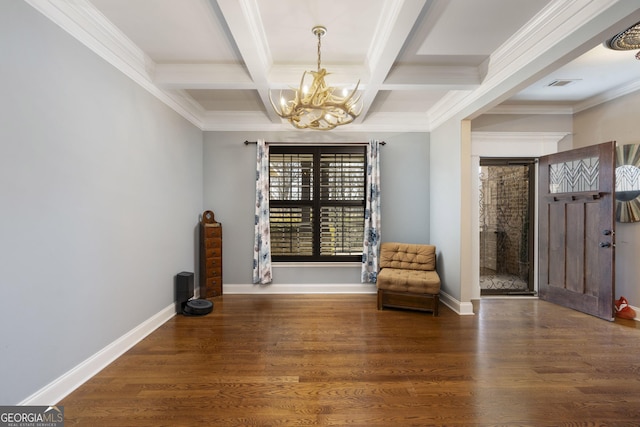 unfurnished room with baseboards, beamed ceiling, wood finished floors, and a notable chandelier