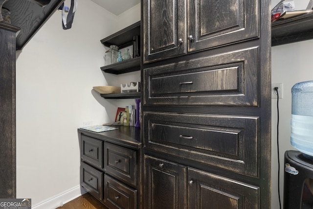 room details featuring baseboards and wood finished floors