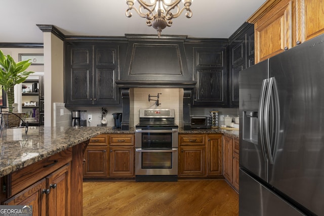 kitchen with premium range hood, appliances with stainless steel finishes, light wood-style flooring, and backsplash