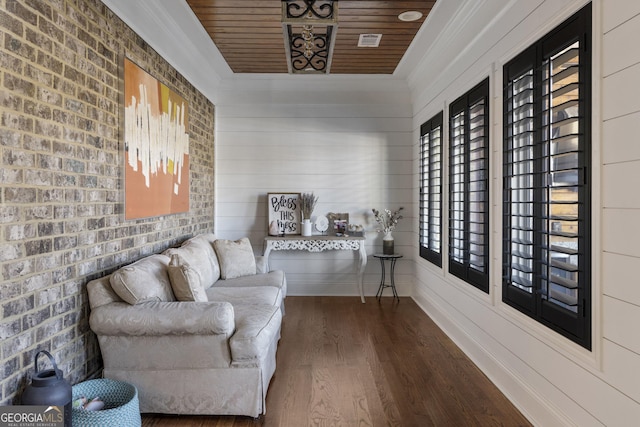 living area with wooden ceiling, dark wood finished floors, and brick wall