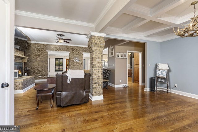 bar featuring beam ceiling, a fireplace, ornate columns, and wood finished floors