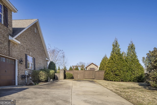 exterior space featuring a garage and a gate