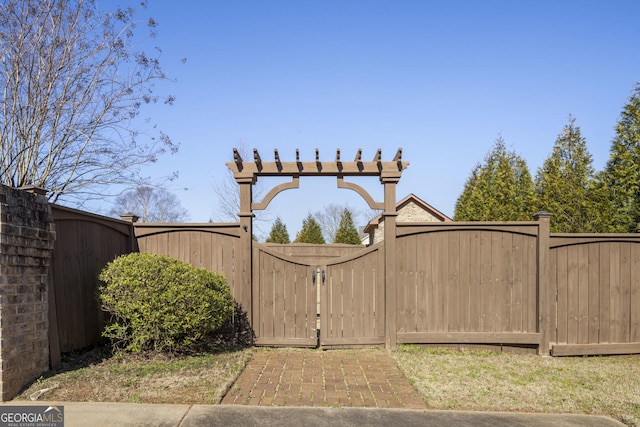 view of gate with fence