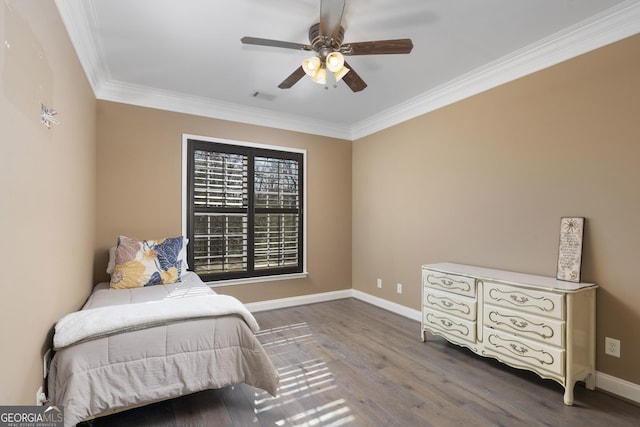 bedroom featuring baseboards, visible vents, a ceiling fan, wood finished floors, and crown molding