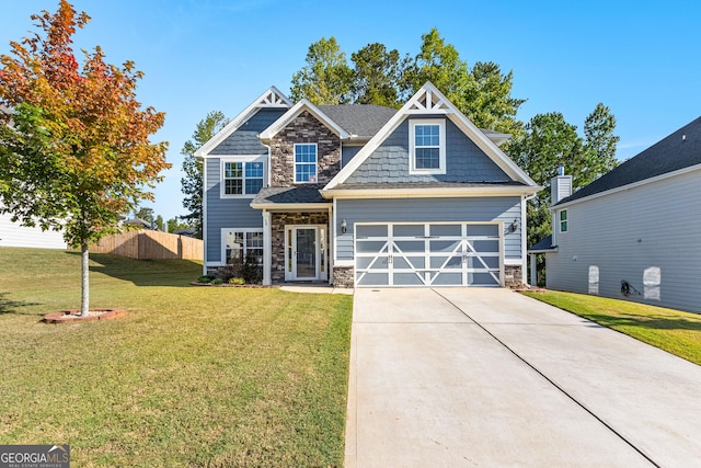 craftsman-style home with stone siding, concrete driveway, fence, and a front yard