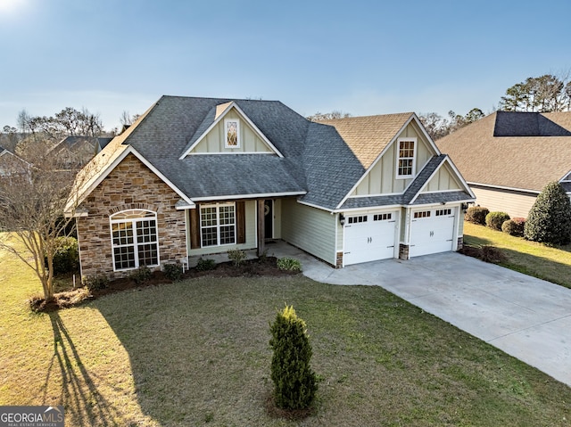 craftsman house featuring board and batten siding, a garage, stone siding, driveway, and a front lawn