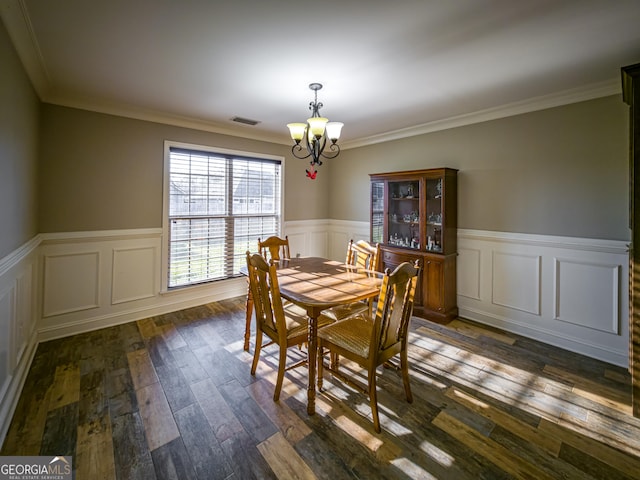 dining room with visible vents, dark wood finished floors, a notable chandelier, and wainscoting