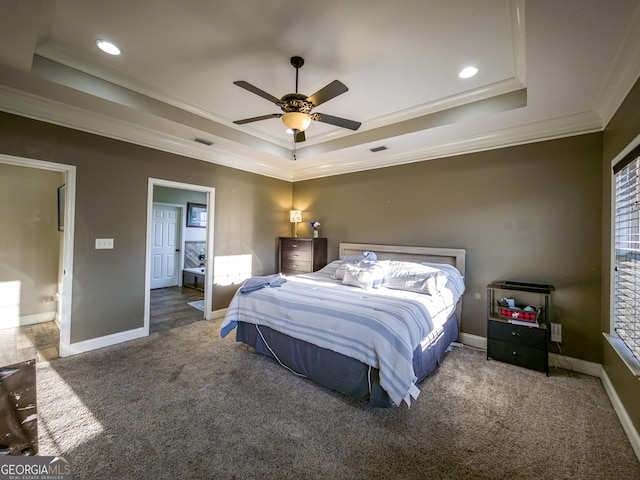 carpeted bedroom with baseboards, visible vents, ornamental molding, a tray ceiling, and recessed lighting