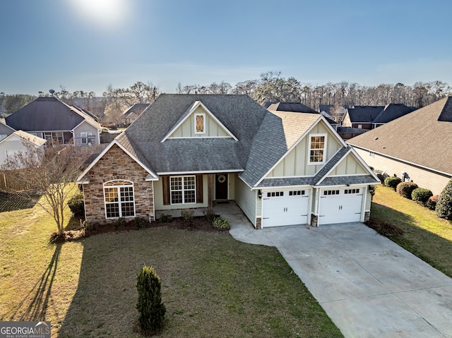 craftsman house with driveway, stone siding, roof with shingles, board and batten siding, and a front yard