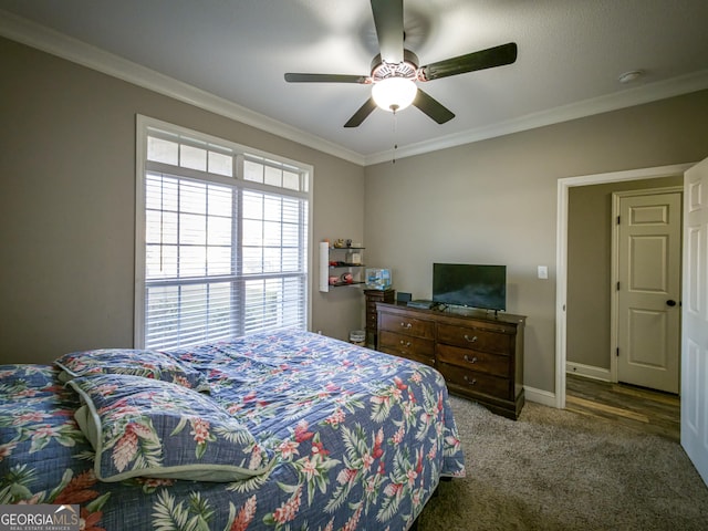 bedroom featuring ceiling fan, ornamental molding, carpet, and baseboards