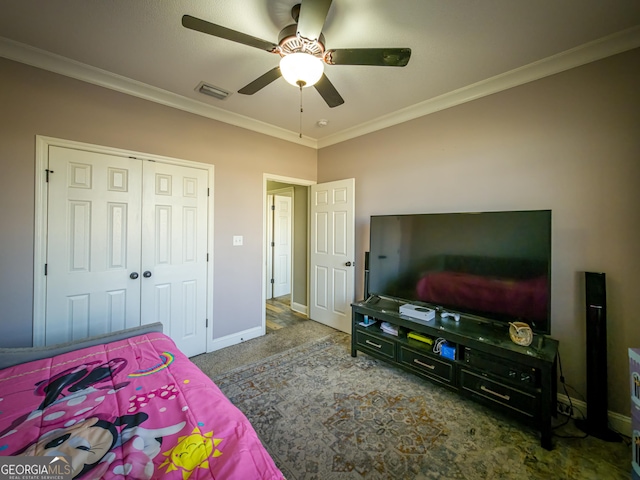 carpeted bedroom featuring ornamental molding, a closet, visible vents, and baseboards