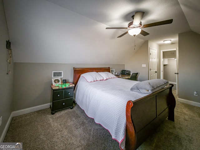 carpeted bedroom featuring lofted ceiling, visible vents, baseboards, and a ceiling fan