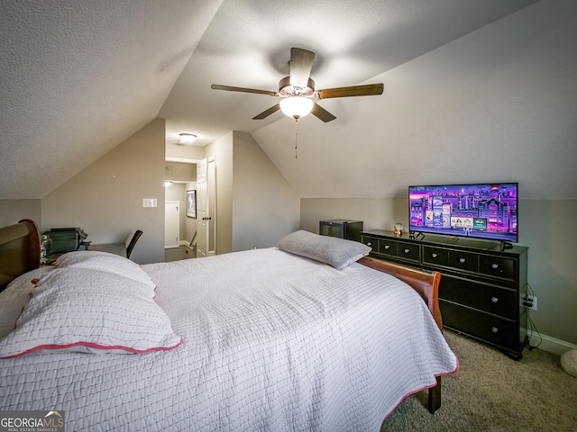 carpeted bedroom featuring baseboards, a ceiling fan, vaulted ceiling, and a textured ceiling