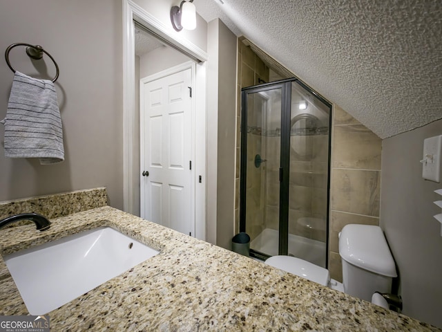 bathroom with a textured ceiling, lofted ceiling, toilet, vanity, and a shower stall