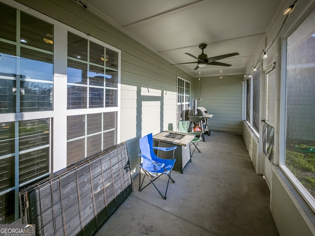 unfurnished sunroom with a ceiling fan and a healthy amount of sunlight