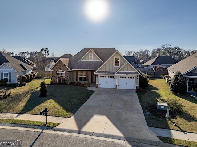 craftsman house featuring a garage, fence, driveway, board and batten siding, and a front yard