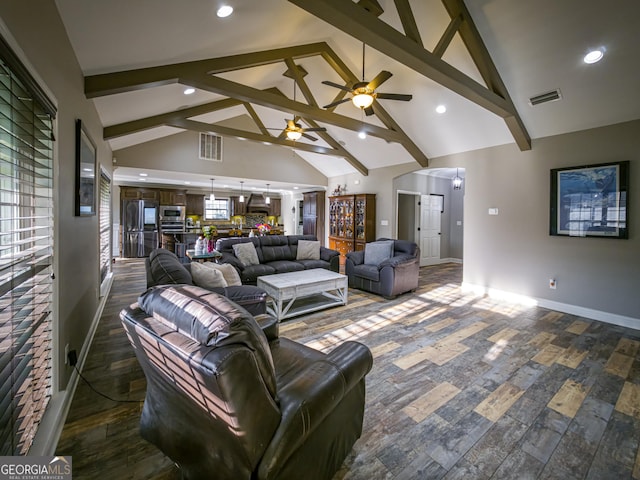 living room featuring high vaulted ceiling, beam ceiling, visible vents, and baseboards