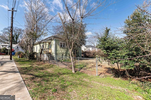 view of home's exterior featuring a yard and fence