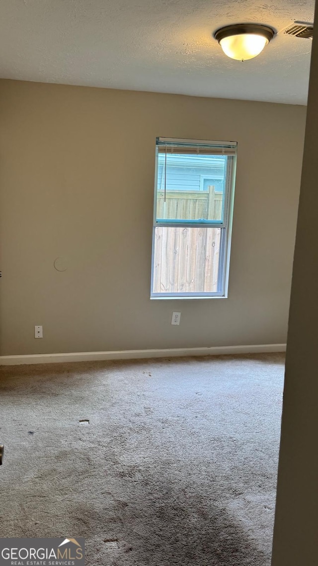 4778 Pebble Trce, Buford, GA 30518 - carpeted spare room featuring a textured ceiling, baseboards, and visible vents