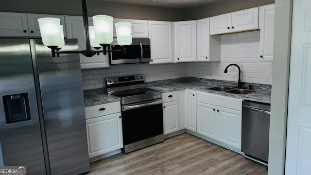 4778 Pebble Trce, Buford, GA 30518 - kitchen featuring white cabinetry, backsplash, appliances with stainless steel finishes, and a sink