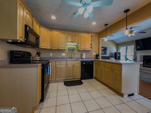 kitchen featuring light tile patterned floors, a peninsula, hanging light fixtures, black appliances, and a sink