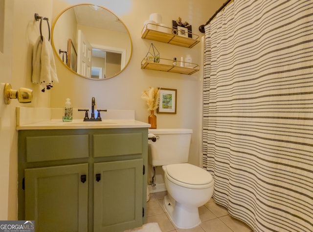 bathroom with curtained shower, vanity, toilet, and tile patterned floors