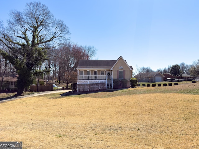 view of front of home with covered porch and a front lawn