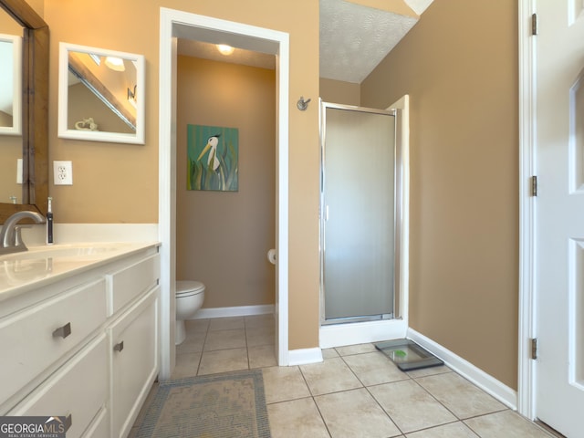 full bathroom featuring toilet, a stall shower, vanity, a textured ceiling, and tile patterned flooring