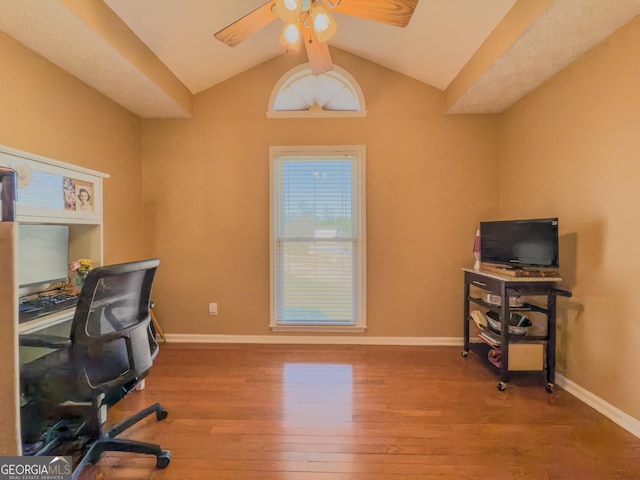 office featuring vaulted ceiling, wood finished floors, a ceiling fan, and baseboards