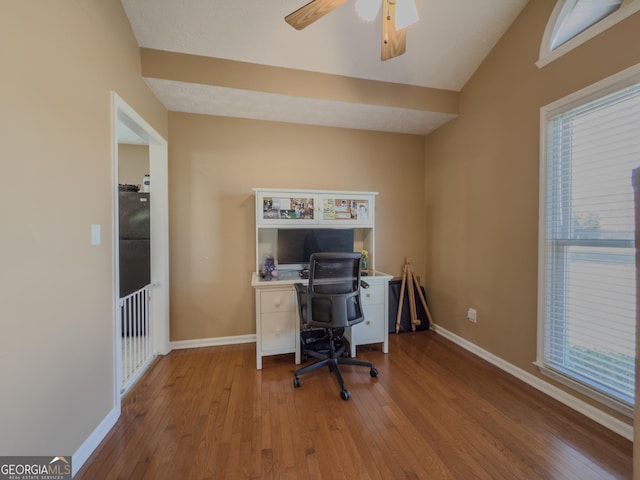 office area with a healthy amount of sunlight, hardwood / wood-style flooring, and baseboards