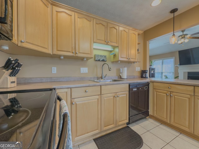 kitchen with light tile patterned floors, a sink, light countertops, light brown cabinetry, and black appliances