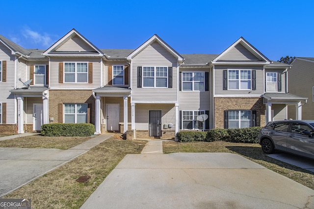 townhome / multi-family property with brick siding