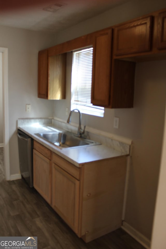 kitchen with dark wood-style floors, light countertops, visible vents, a sink, and dishwasher