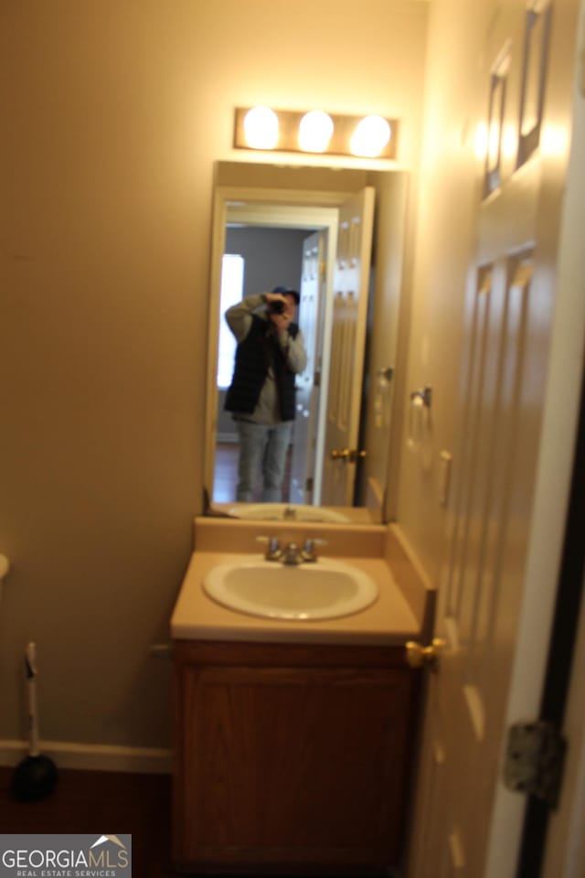 bathroom featuring vanity and baseboards