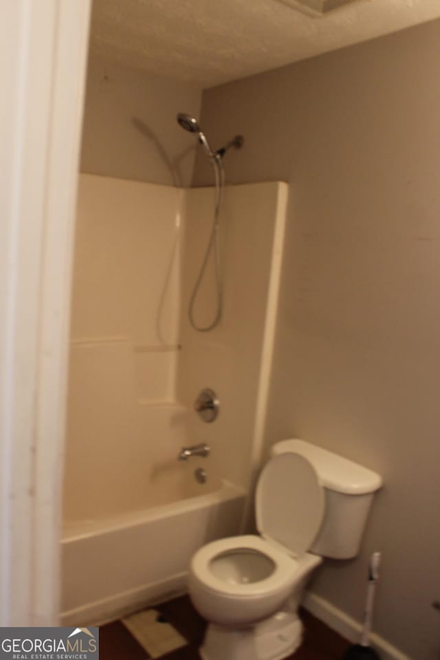 full bathroom featuring bathing tub / shower combination and toilet