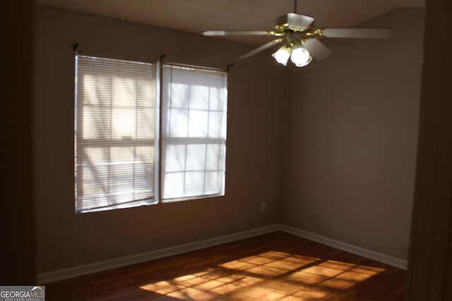 unfurnished room with ceiling fan, baseboards, and wood finished floors