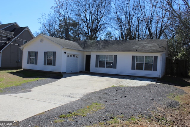 ranch-style house with concrete driveway and an attached garage