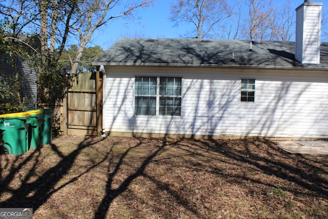 view of side of home featuring a chimney