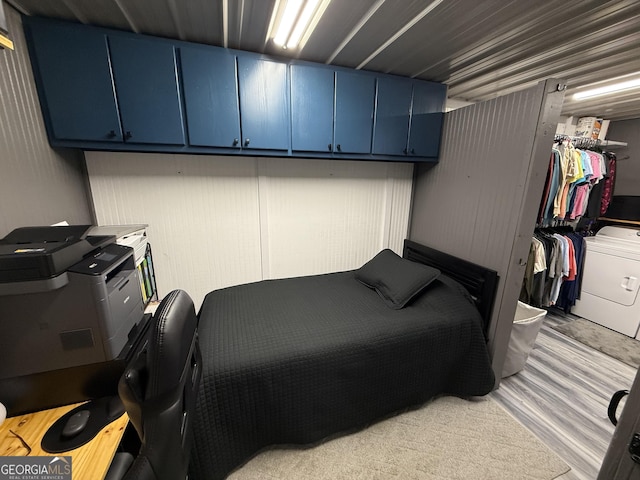 bedroom with light wood-style flooring, a walk in closet, and a closet