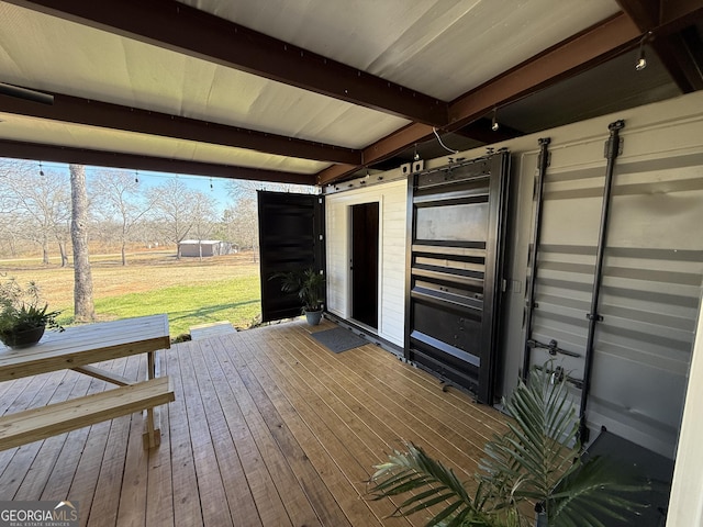 wooden deck featuring a lawn