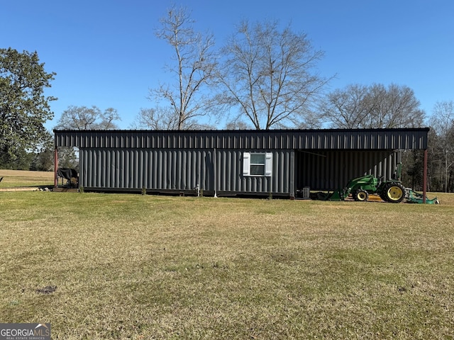 exterior space featuring a pole building, a front lawn, and an outdoor structure