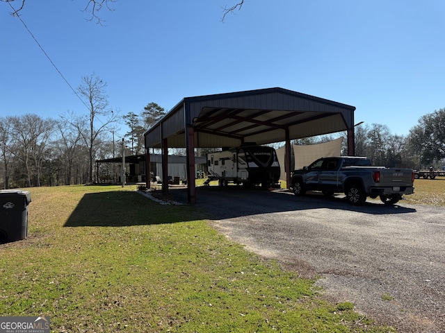 view of parking / parking lot featuring a detached carport and driveway