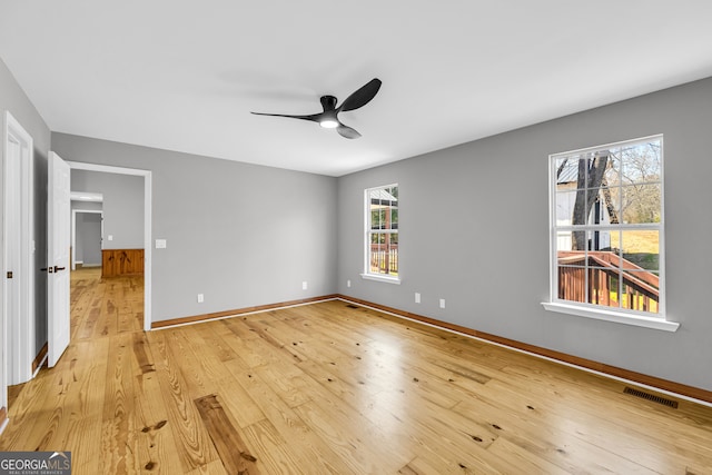 unfurnished bedroom featuring ceiling fan, light wood-type flooring, visible vents, and baseboards