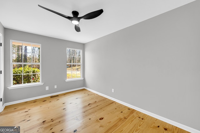 unfurnished room featuring visible vents, ceiling fan, baseboards, and wood finished floors