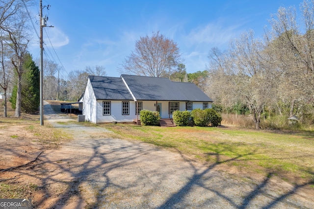 ranch-style home featuring a carport, a front yard, and driveway