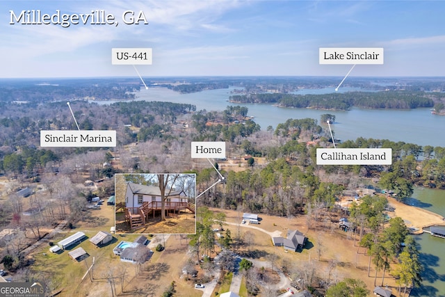birds eye view of property featuring a water view and a view of trees
