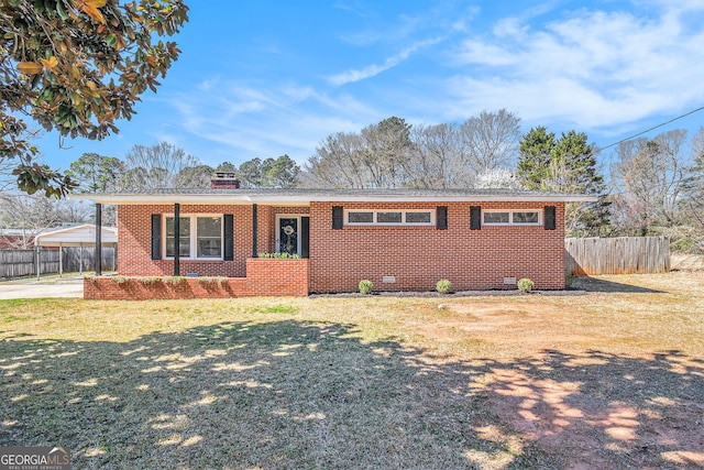 ranch-style home featuring brick siding and a chimney