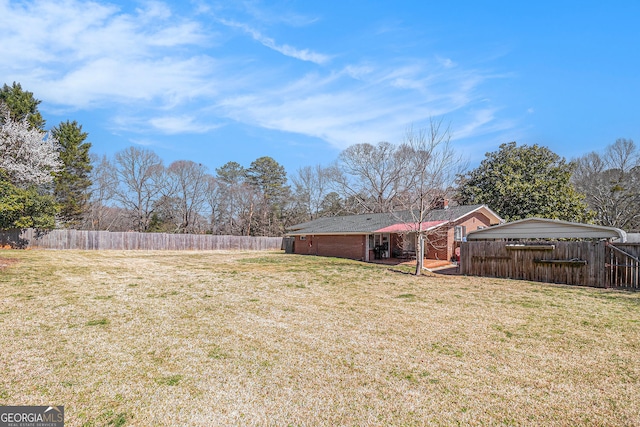 view of yard with a fenced backyard